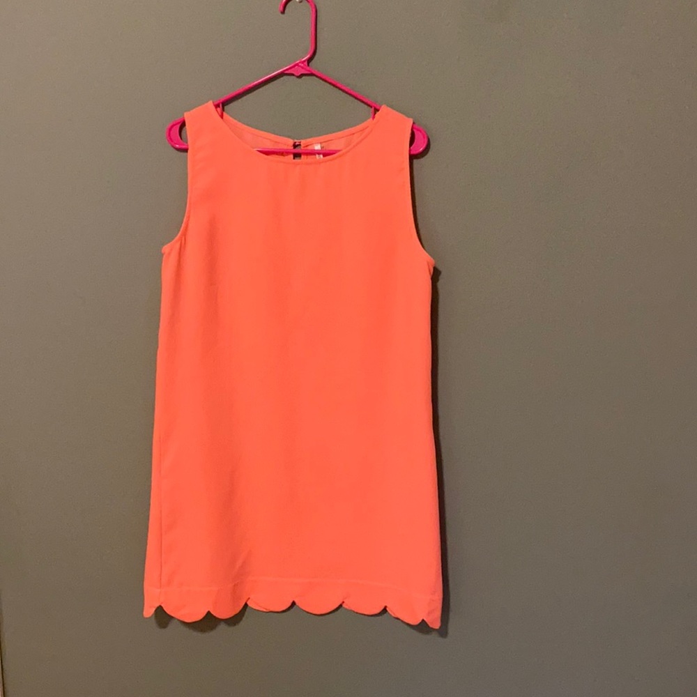 Coral scalloped hemmed dress.